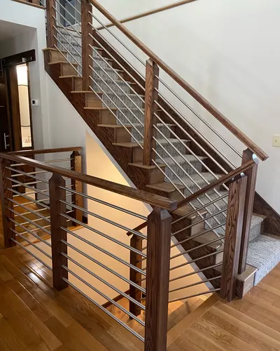 Patterned carpet runner on oak stairs