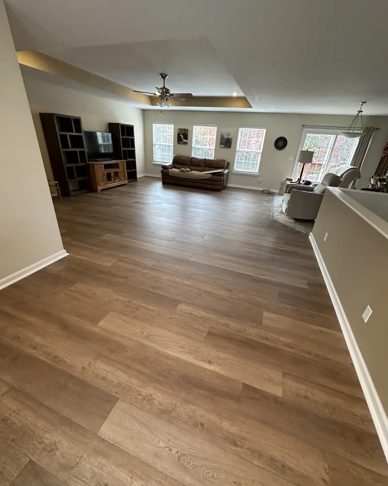 Wood-look vinyl plank running through an open living room